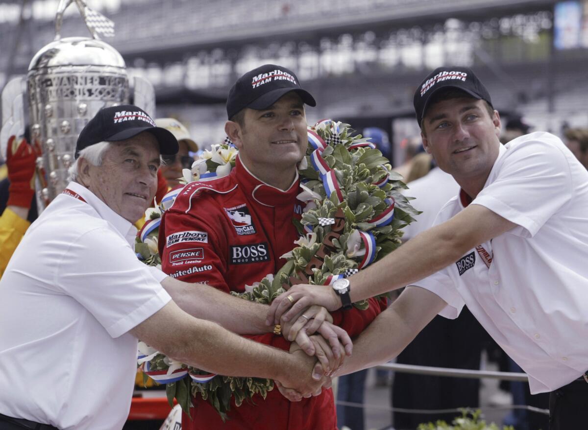 2003 Indy 500 winner Gil de Ferran celebrates with team owner Roger Penske (L) and Team boss Tim Cindric (R)