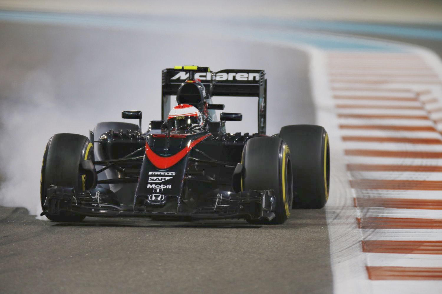 Button locks a wheel in his McLaren