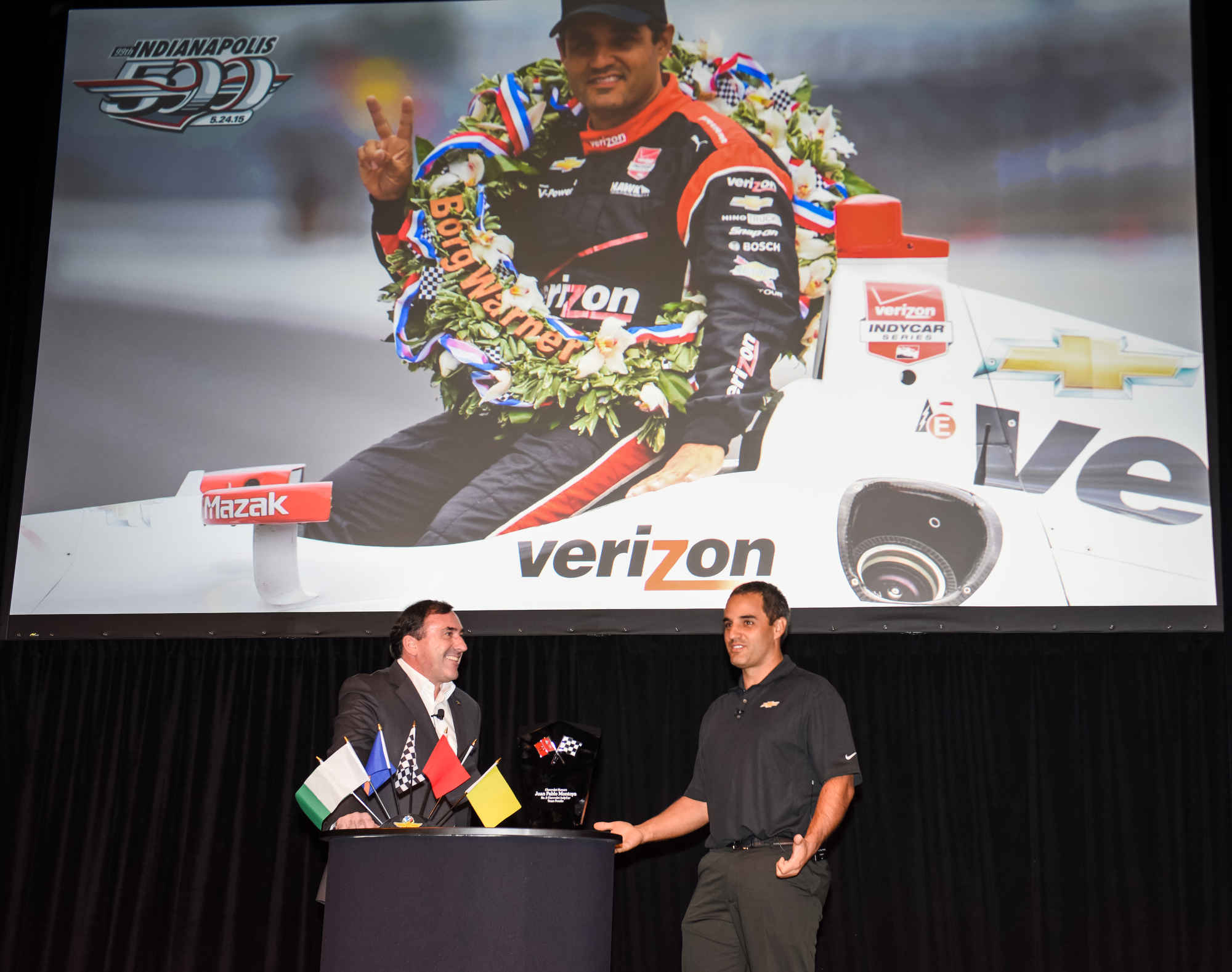 General Motors Executive Vice President and President North America Alan Batey (left) congratulates Juan Pablo Montoya, driver of the #2 Verizon Team Penske Chevrolet IndyCar V-6 