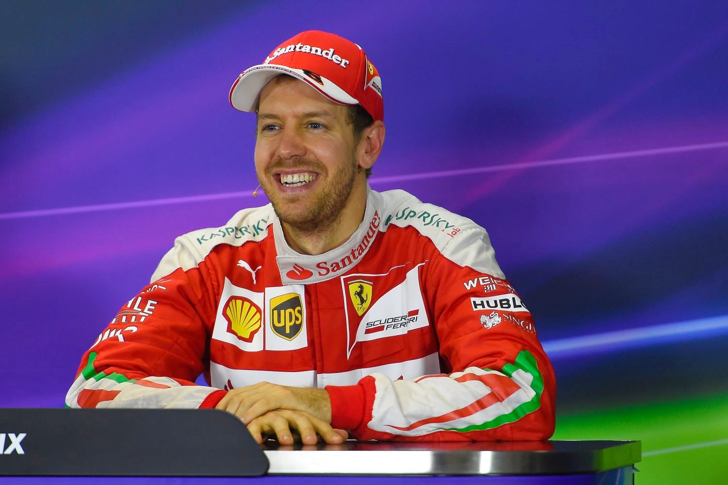 Vettel smiles at the post-race press conference