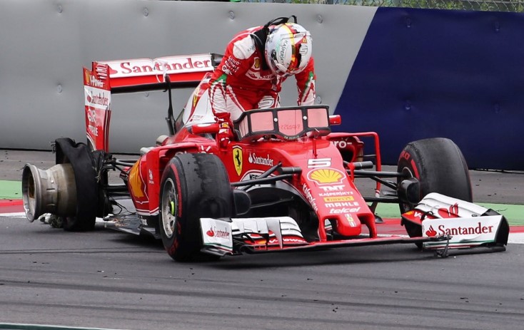Vettel climbs from his crashed Ferrari