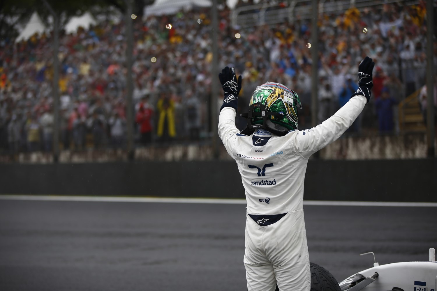 Massa waves to fans after he crashed out of his last Brazilian GP