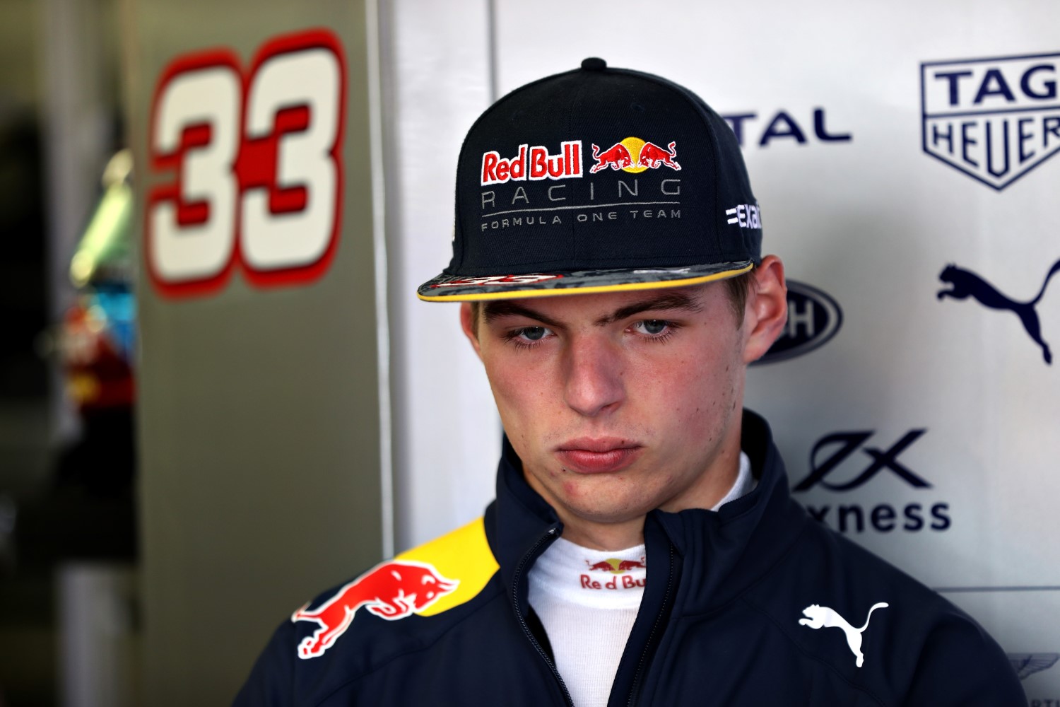 Max Verstappen looks dejected after the FIA reprimand