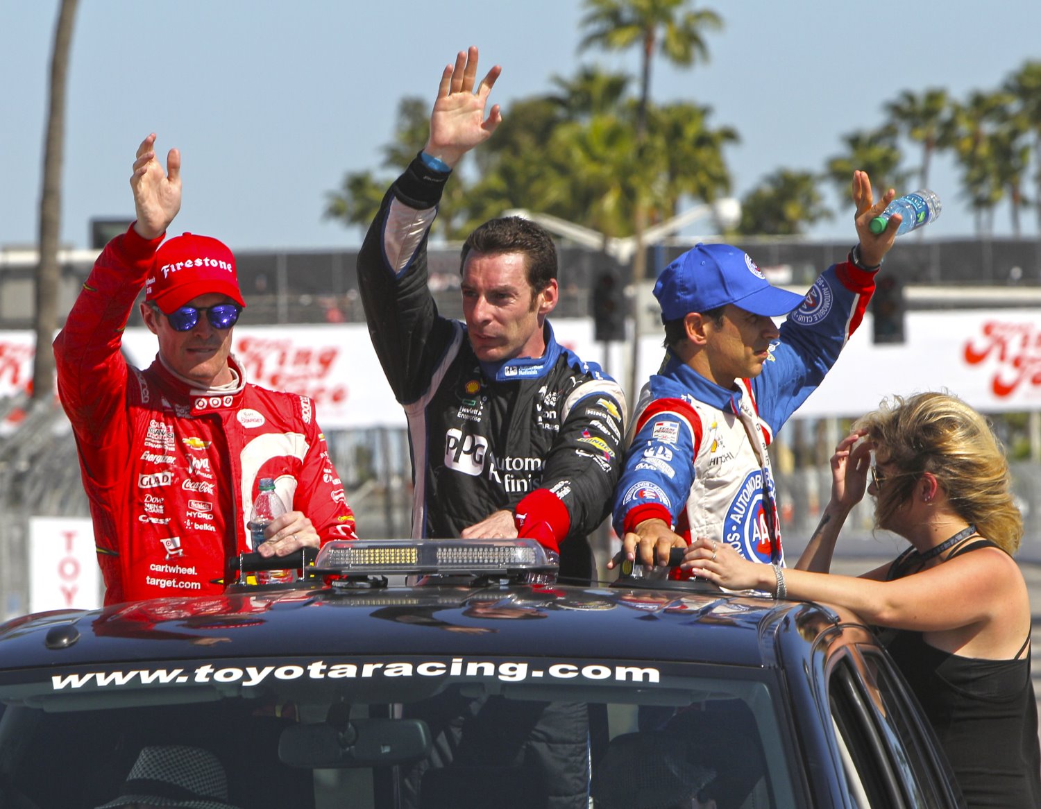 Dixon, Pagenaud and Castroneves wave to the fans after the race