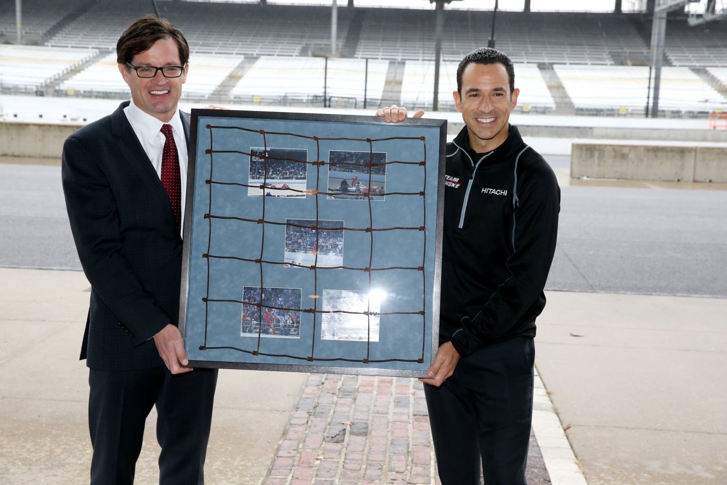 Doug Boles presents Castroneves with piece of fence