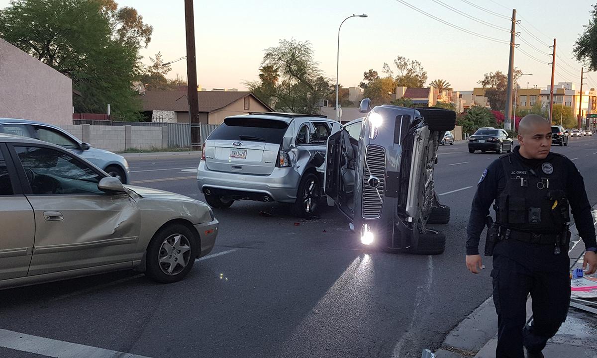 An image from a video distributed by Fresco News shows a Volvo flipped on its side after an apparent collision involving two other vehicles in Tempe, Ariz.