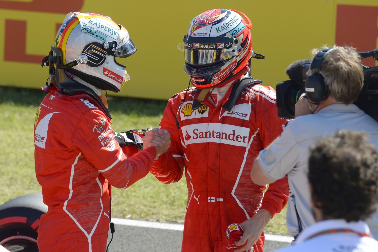 Raikkonen (R) congratulates Vettel