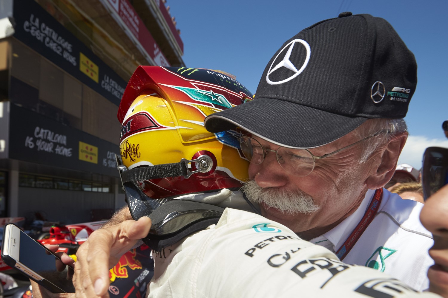 Dieter Zetsche hugs Hamilton after winning in Spain