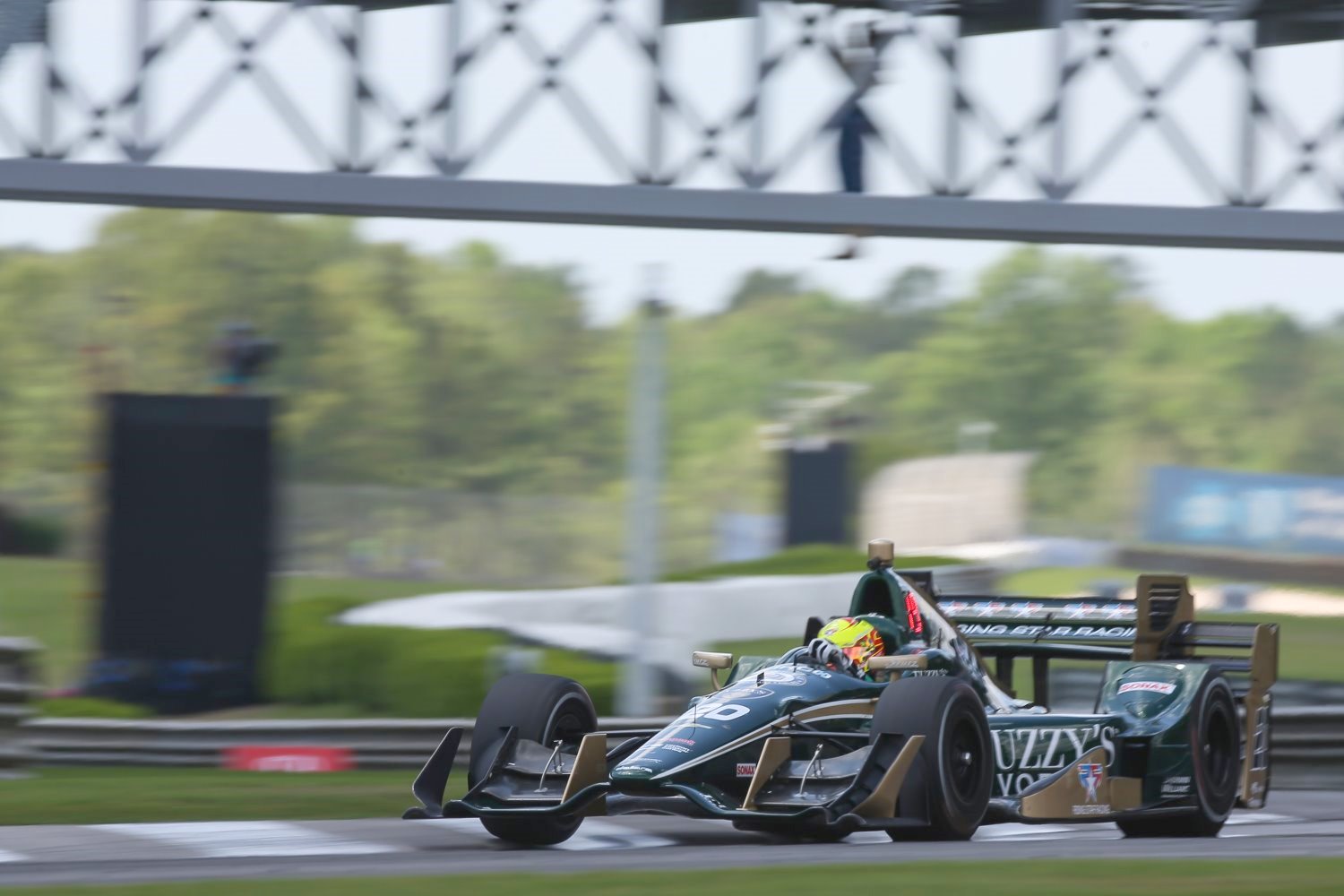 Spencer Pigot speeds under the bridge and you can make out Georgina hanging from the truss work.