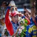 Race winner Takuma Sato pours milk over his head