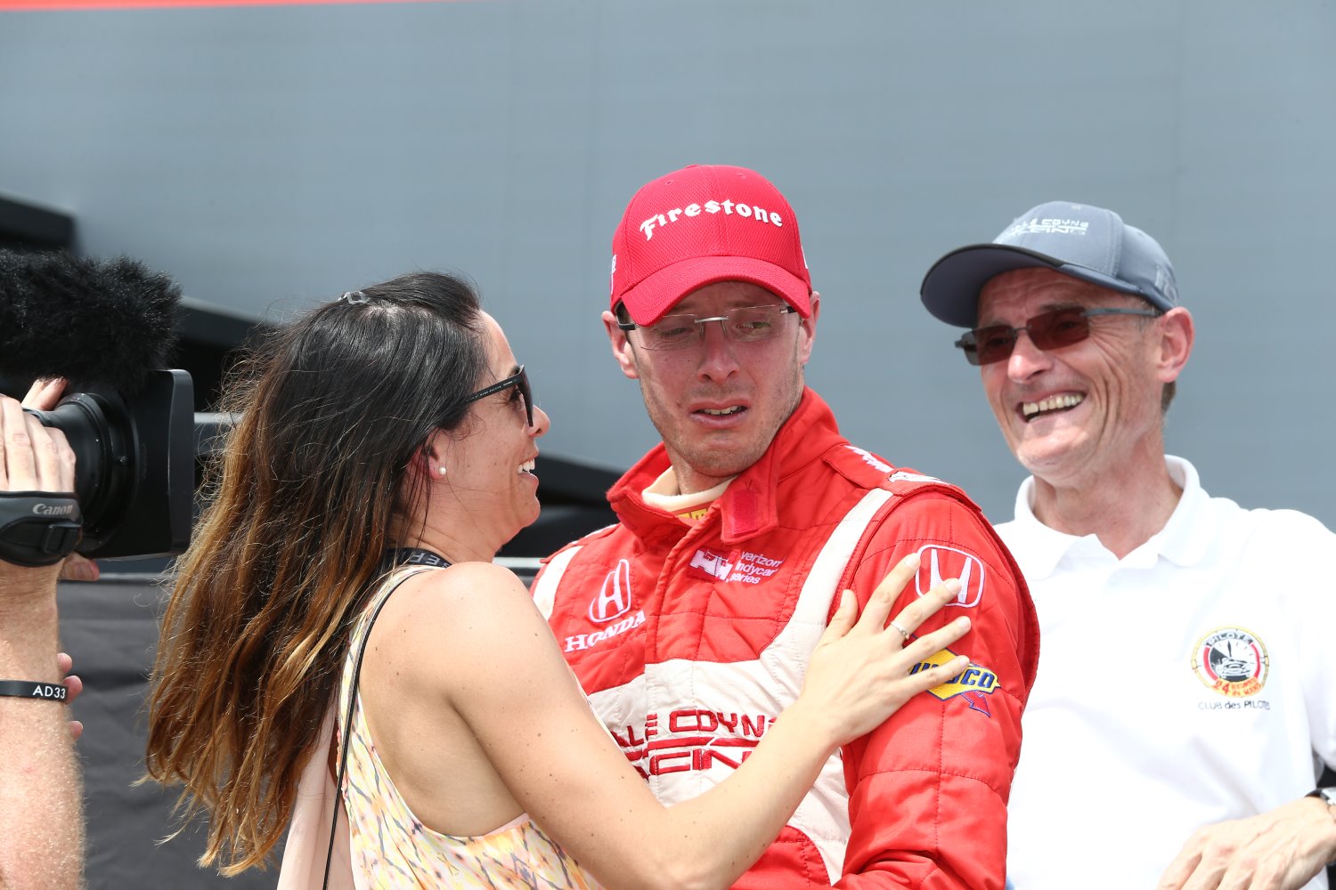 Race winner Bourdais is overcome with emotion as he celebrates with wife Claire and his father