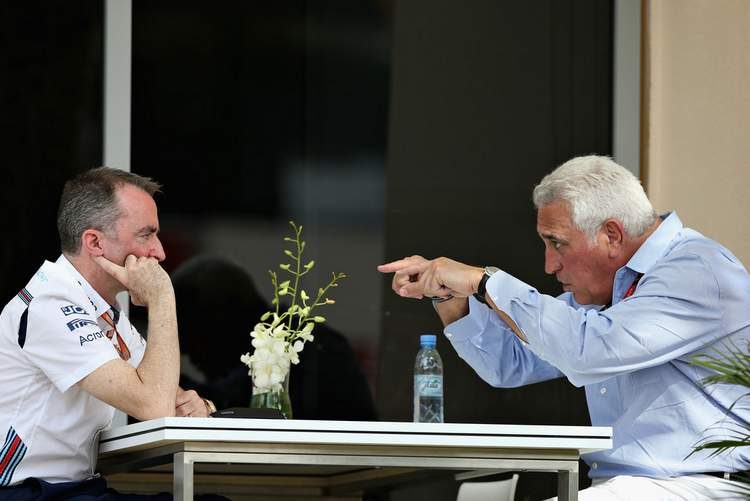 Lawrence Stroll (R) berates Paddy Lowe - probably saying 'I pay $40M a year and were're running last. Fix your crap car or I will have you fired.'