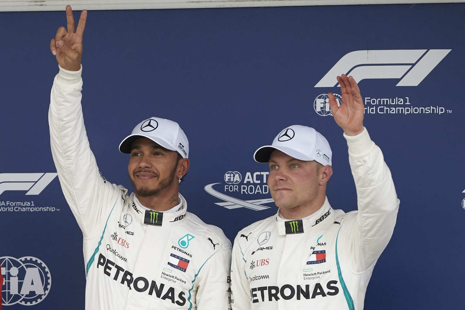 Hamilton (L) and his slave driver Bottas, wave to the crowd in Brazil
