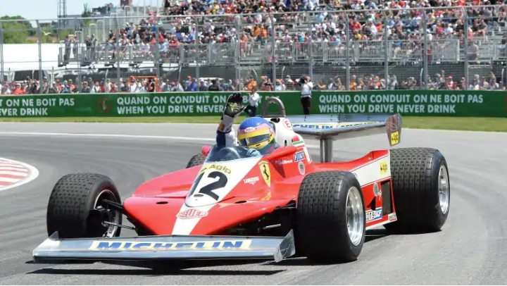 Former Formula 1 racer Jacques Villeneuve drives his father Gilles Villeneuve's 1978 Ferrari during the drivers' parade prior to the Canadian Grand Prix Sunday. 