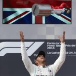 Hamilton tosses his trophy