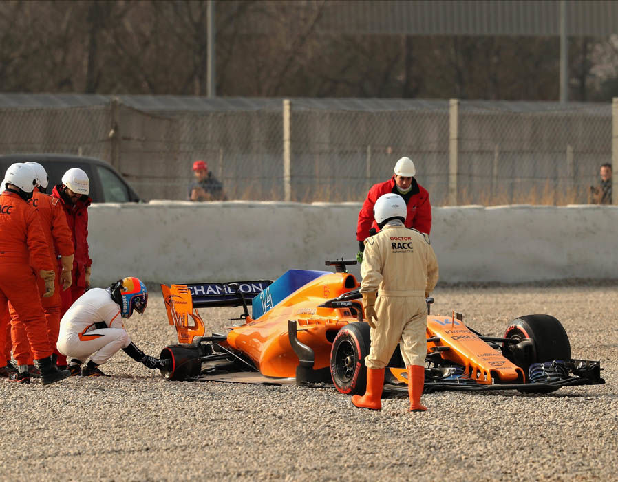 Alonso looks at car in gravel trap. It must have been Honda's fault