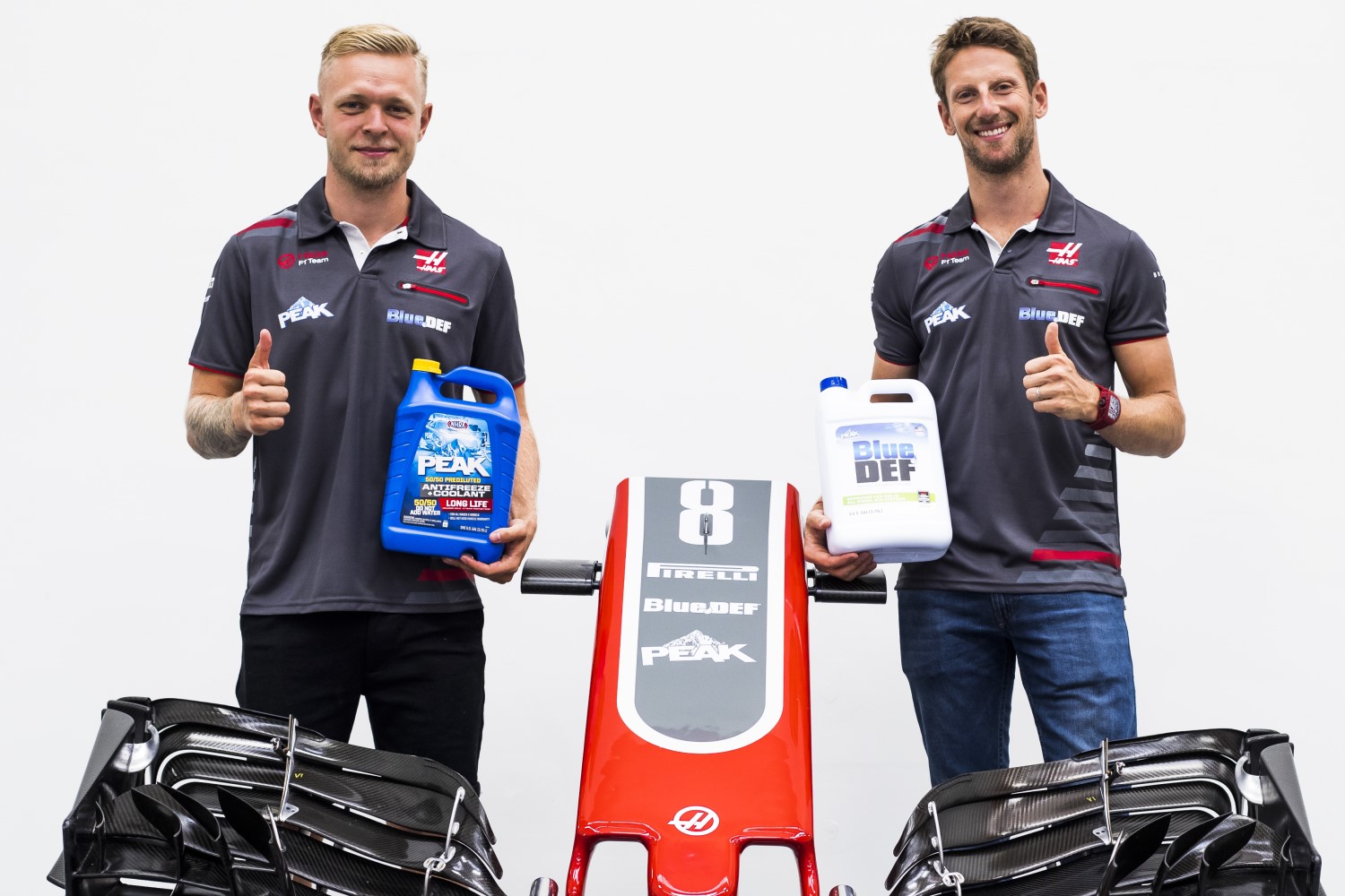 Magnussen and Grosjean show off bottles from new sponsors