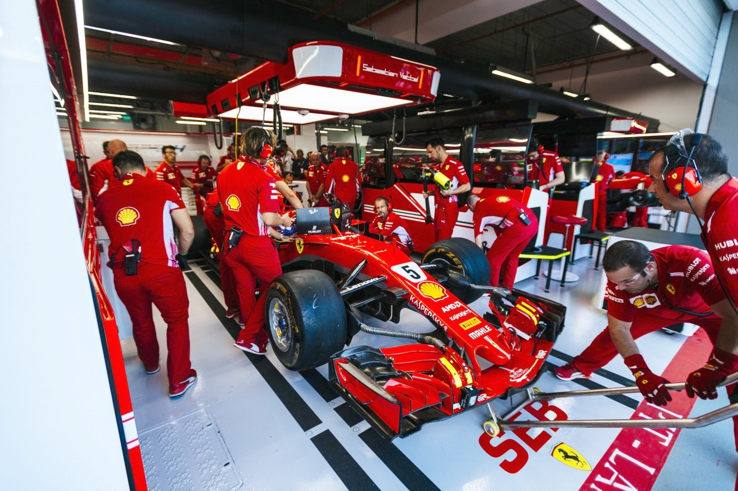 Vettel's damaged Ferrari gets service in garage