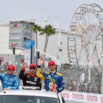 IndyCar winner, Alexander Rossi, right, with Will Power, center, who took second place and the third place winner, Ed Jones, left, during a victory lap after the IndyCar Race during during the Toyota Grand Prix of Long Beach