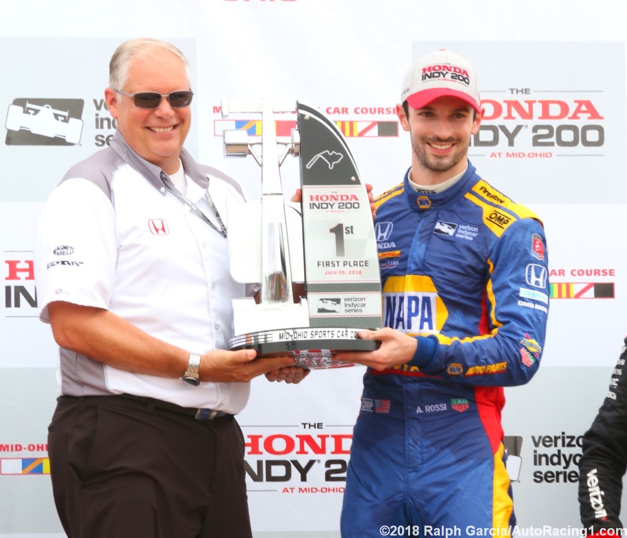 Honda HPD boss Art St. Cyr presents Alexander Rossi with his winner's trophy