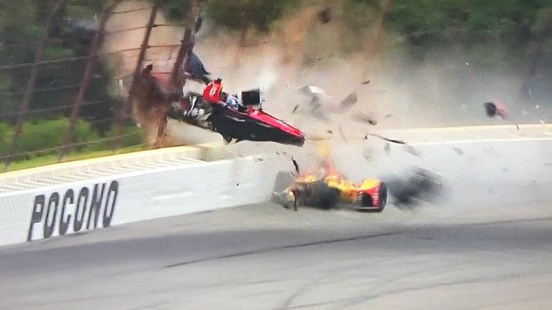 Wickens hits catch-fence post which breaks his back, both legs and right arm