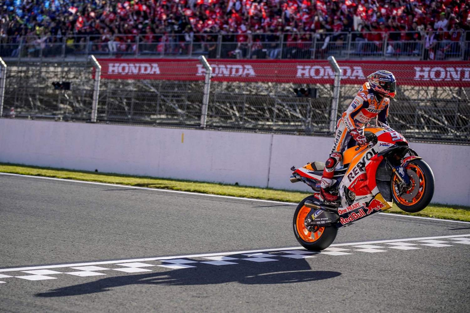 Marquez storms across the line doing a wheelie to win