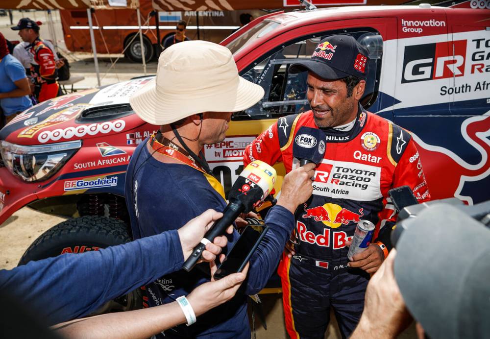 Nasser tells the press how he outran the Peugeots in his Toyota