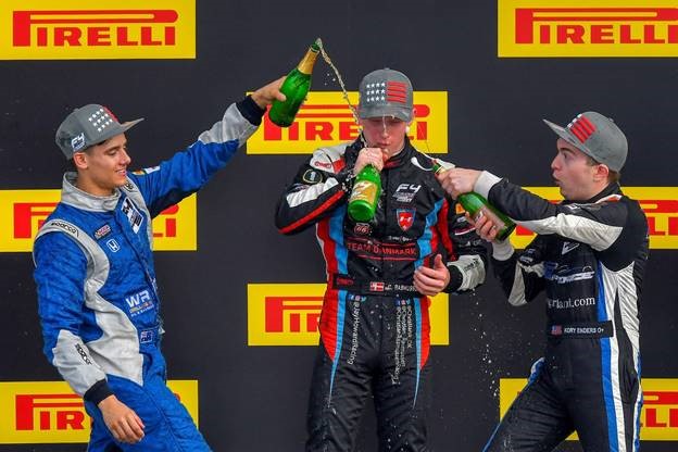 Christian Rasmussen celebrates his fifth win of the season along side Joshua Car and Kory Enders