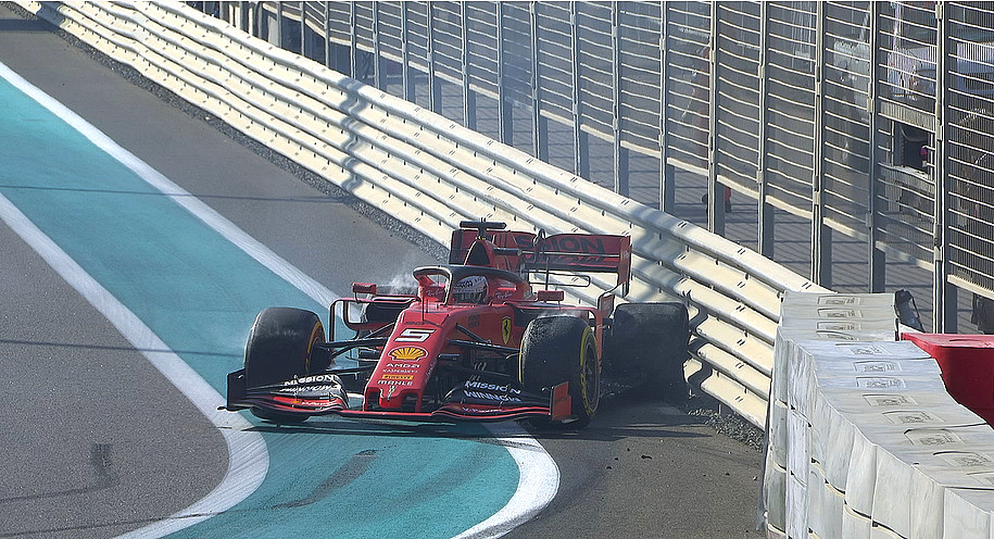 Vettel hits the barrier with his left rear causing damage to the fragile Ferrari
