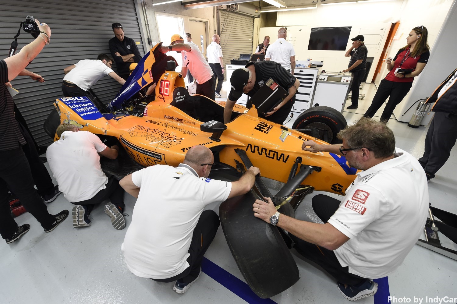 Alonso's team works on his wrecked car