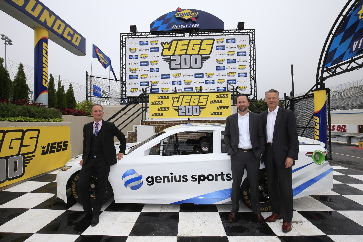 (From left to right) Chris Dougan, Genius Sports Chief Communications Officer and NASCAR's Scott Warfield and Steve Phelps pose for a photo during partnership announcement.
