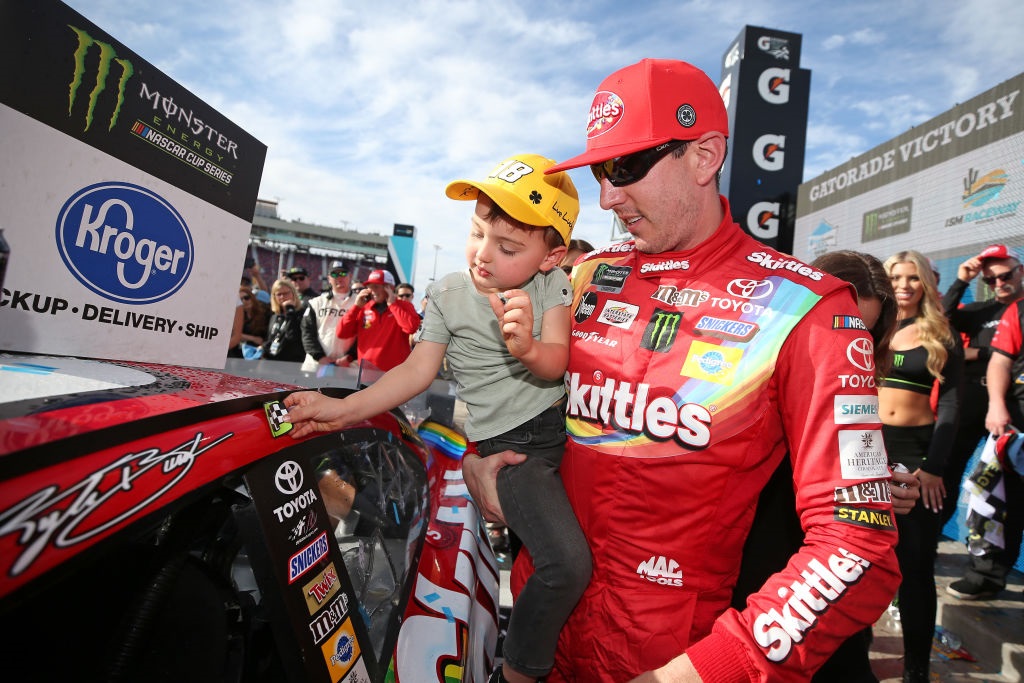 yle Busch, driver of the #18 Skittles Toyota, celebrates with his wife, Samantha, and son, Brexton, after winning the Monster Energy NASCAR Cup Series TicketGuardian 500