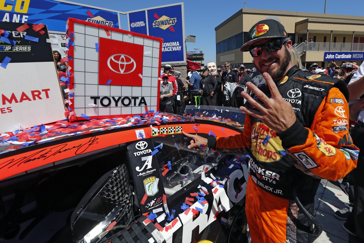 Winner Martin Truex Jr., driver of the #19 Bass Pro Shops Toyota