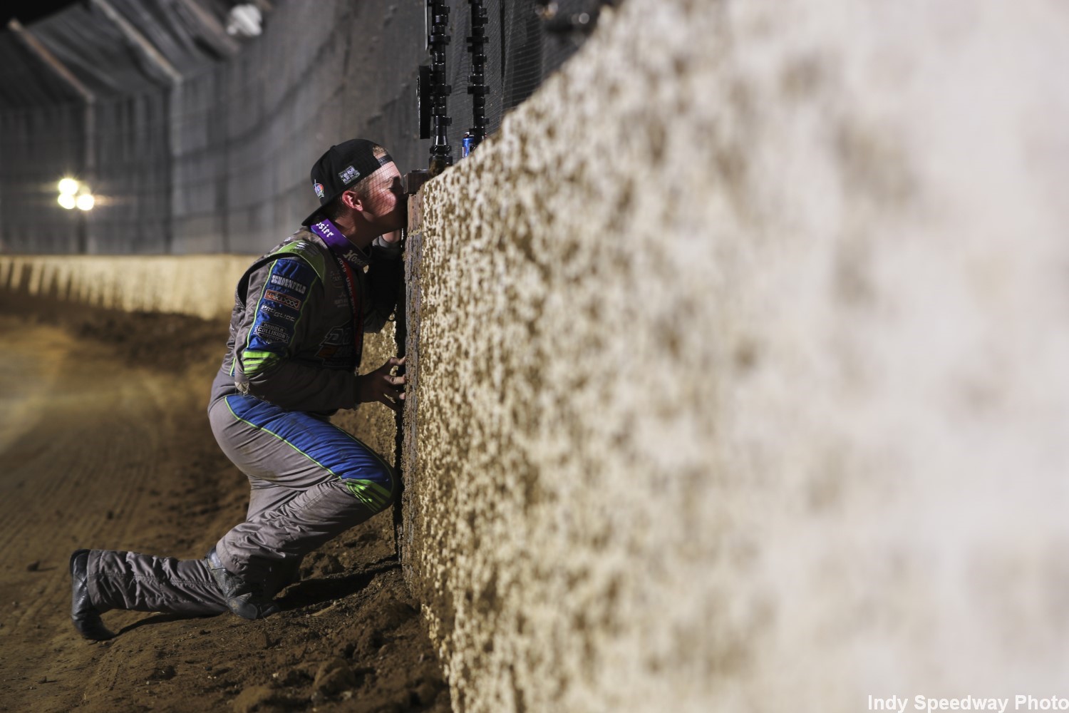 Wise prostrates himself and kisses the filthy dirty yard of bricks in the dirt covered wall