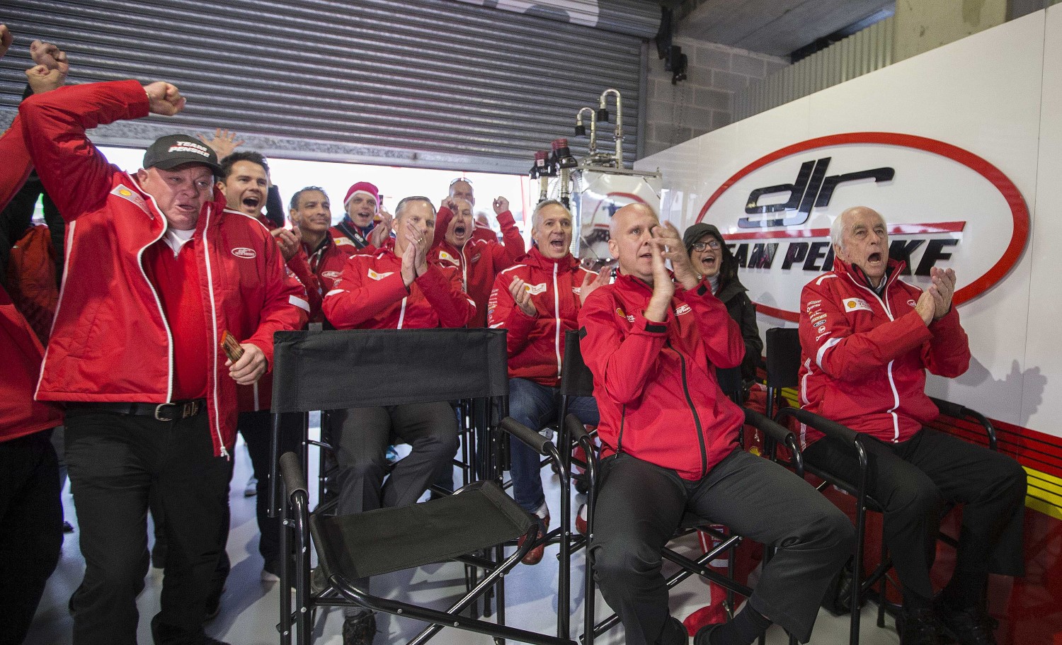 Penske (R) cheers on his driver McLaughlin to pole