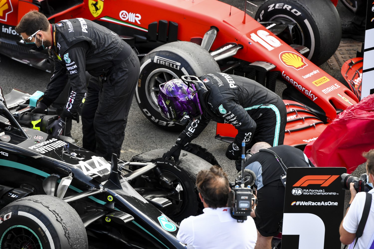 Hamilton examines his blown Pirelli. The cars that generate the most downforce - Mercedes and McLaren - blew out their tires