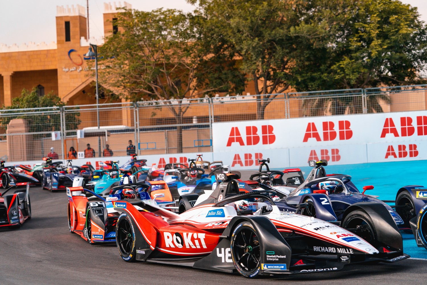 Edoardo Mortara (ROKiT Venturi Racing) following a group of Formula E cars through the congested first chicane at the recent  SAUDIA Diriyah E-Prix