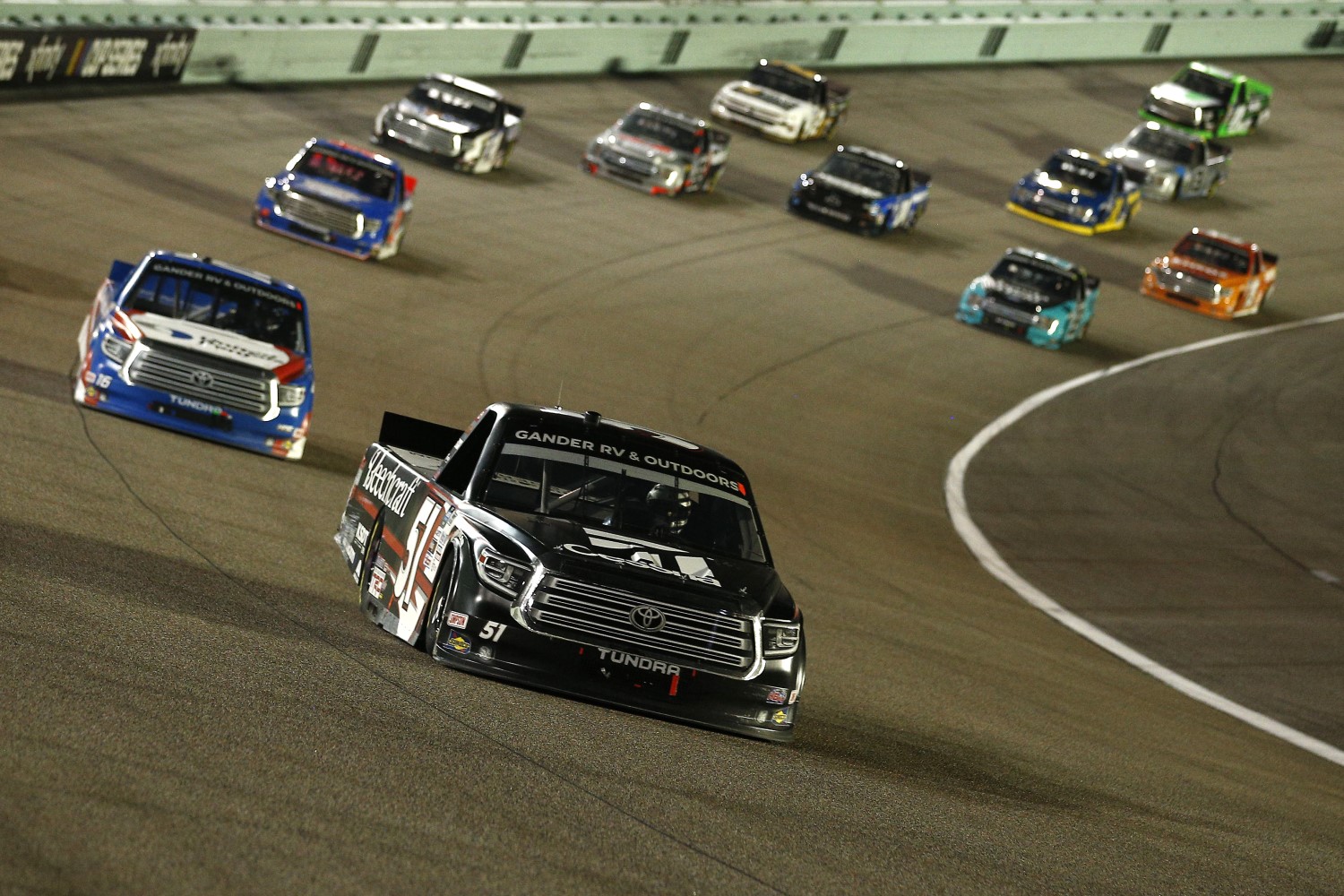 Kyle Busch, driver of the #51 Cessna Toyota, leads a pack of trucks