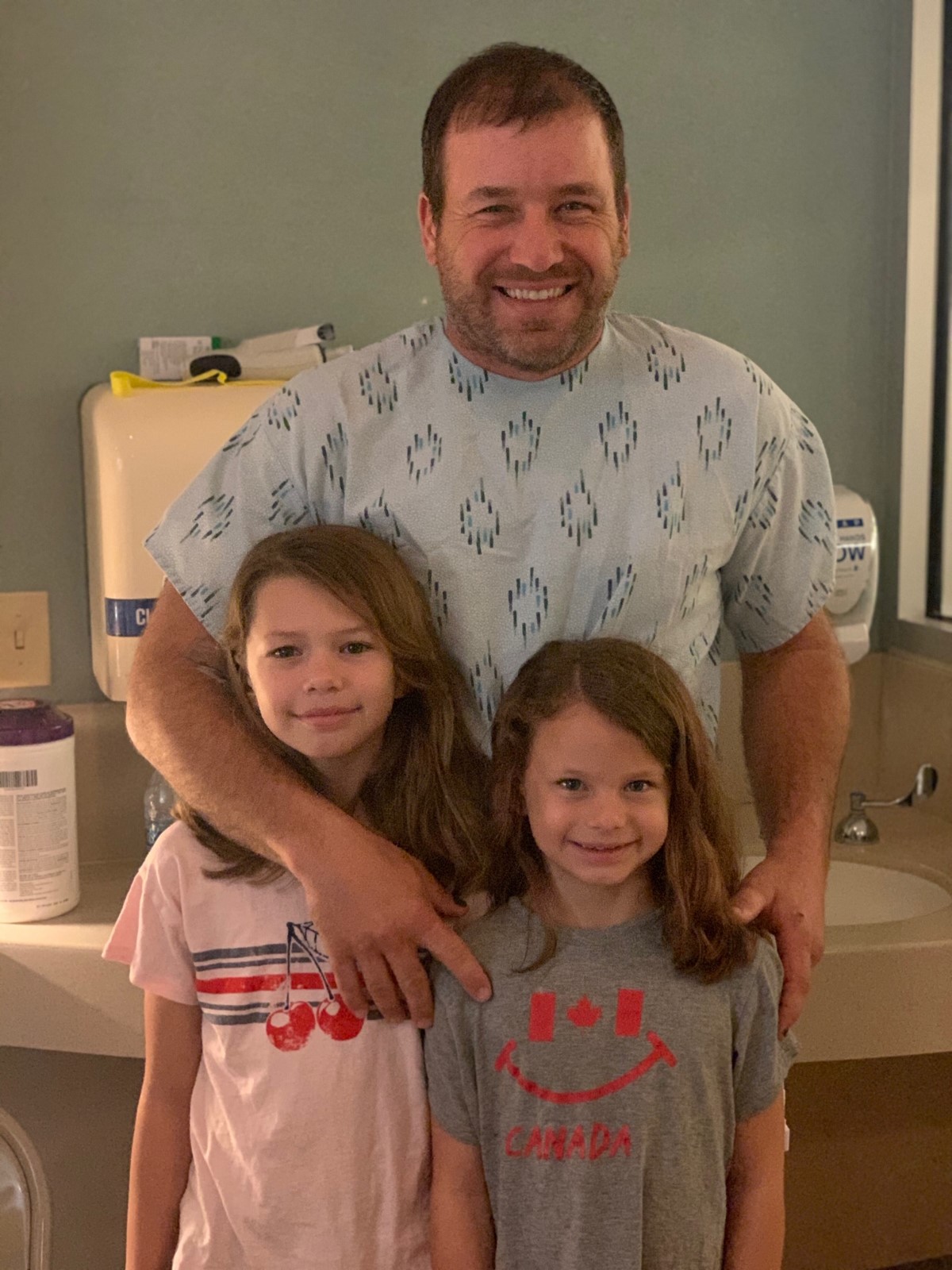Newman with his two daughters in hospital