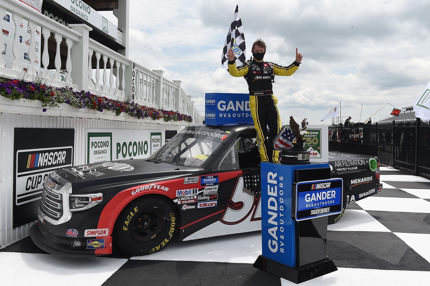 Brandon Jones, driver of the #51 DuPont Air Filtration/Menards Toyota, celebrates in Victory Lane