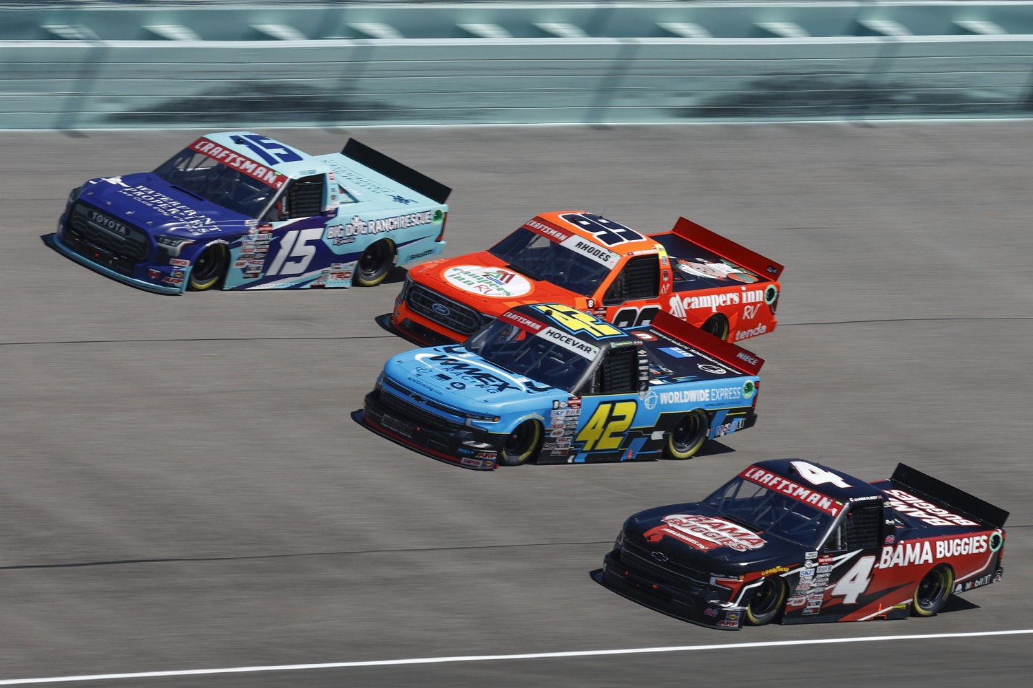 Chase Purdy, driver of the #4 Bama Buggies Chevrolet, Carson Hocevar, driver of the #42 Worldwide Express Chevrolet, Ben Rhodes, driver of the #99 Campers Inn RV Ford, and Tanner Gray, driver of the #15 Waterfront Properties Toyota, rduring the NASCAR Craftsman Truck Series Baptist Health Cancer Care 200 at Homestead-Miami Speedway on October 21, 2023 in Homestead, Florida. (Photo by Sean Gardner/Getty Images)