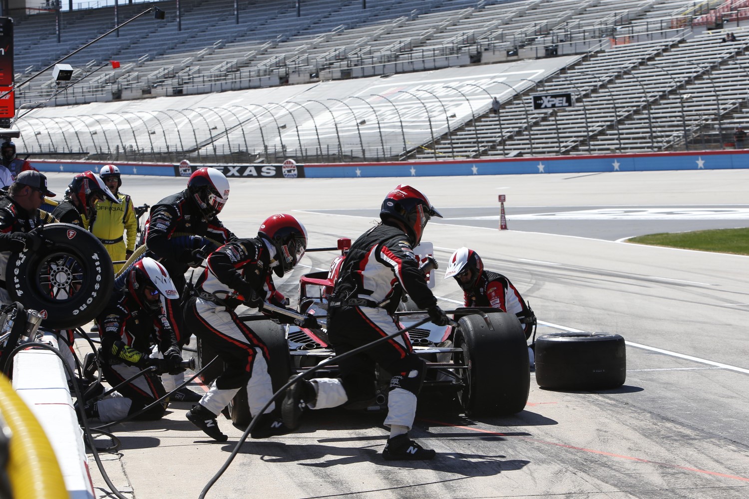 2022 Rinus Veekay Pitstop at Texas Motor Speedway. Note the empty grandstands. You could shoot a cannon into the grandstands and not hit anyone. Media Credit: Penske Entertainment: Chris Jones