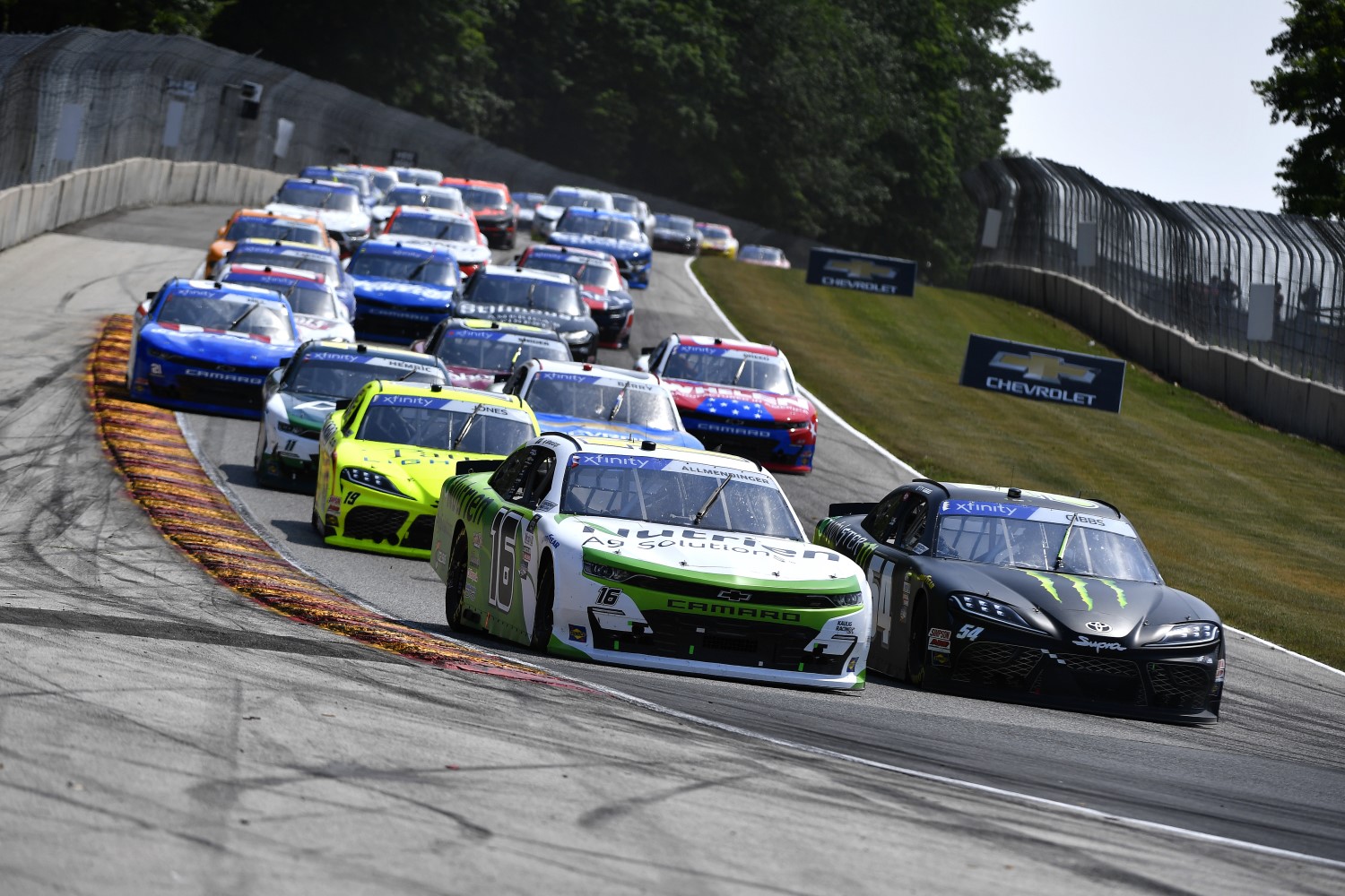 Road America - JULY 02: AJ Allmendinger, driver of the #16 Nutrien Ag Solutions Chevrolet, and Ty Gibbs, driver of the #54 Monster Energy Toyota, race during the NASCAR Xfinity Series Henry 180 at Road America on July 02, 2022 in Elkhart Lake, Wisconsin. (Photo by Logan Riely/Getty Images)