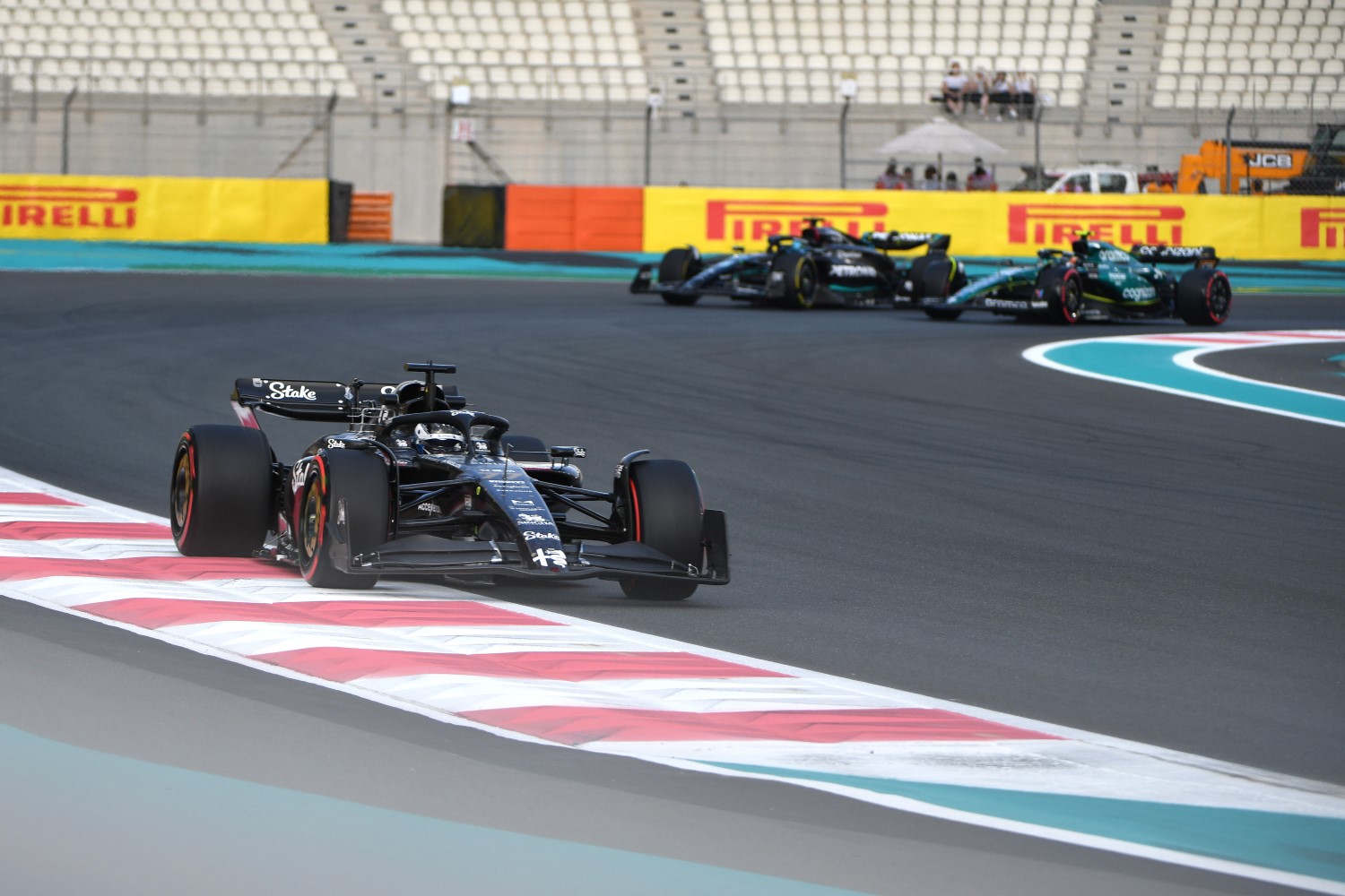 Valtteri Bottas, Alfa Romeo C43, leads George Russell, Mercedes F1 W14, and Fernando Alonso, Aston Martin AMR23 during the Abu Dhabi GP at Yas Marina Circuit on Friday November 24, 2023 in Abu Dhabi, United Arab Emirates. (Photo by James Sutton / LAT Images)