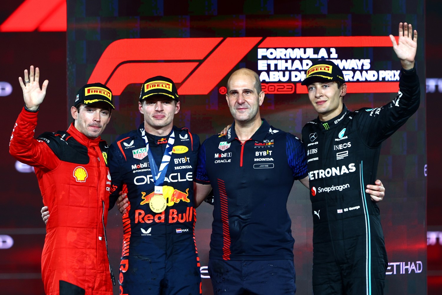 Race winner Max Verstappen of the Netherlands and Oracle Red Bull Racing, Second placed Charles Leclerc of Monaco and Ferrari, Third placed George Russell of Great Britain and Mercedes and Jamie Meades, Head Of Supply Chain Operations at Red Bull Racing celebrate on the podium during the F1 Grand Prix of Abu Dhabi at Yas Marina Circuit on November 26, 2023 in Abu Dhabi, United Arab Emirates. (Photo by Clive Rose/Getty Images) // Getty Images / Red Bull Content Pool