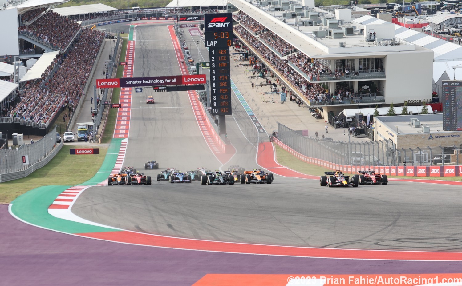 Max Verstappen squeezes Charles Leclerc down the inside into Turn 1