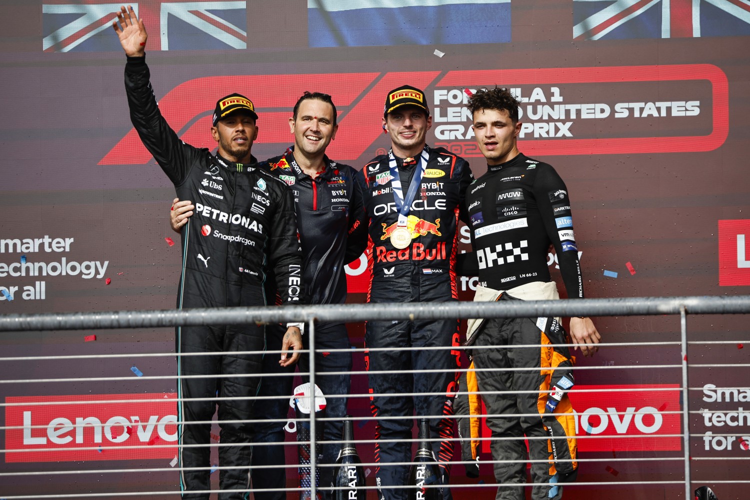 Race winner Max Verstappen of the Netherlands and Oracle Red Bull Racing, Second placed Lewis Hamilton of Great Britain and Mercedes, Third placed Lando Norris of Great Britain and McLaren and John Hammond of Red Bull Racing celebrate on the podium during the F1 Grand Prix of United States at Circuit of The Americas on October 22, 2023 in Austin, Texas. (Photo by Chris Graythen/Getty Images)