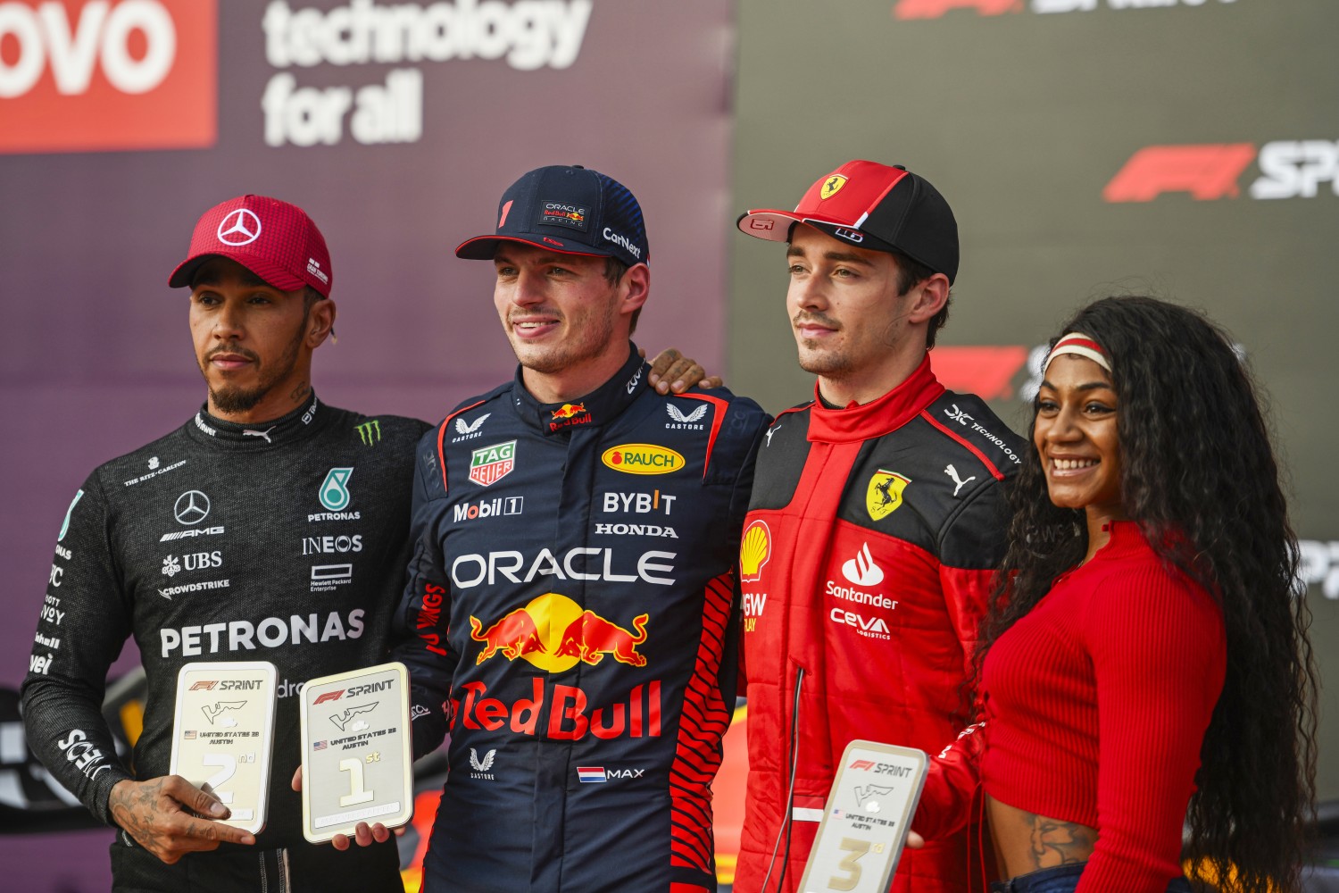 Sprint winner Max Verstappen of the Netherlands and Oracle Red Bull Racing, Second placed Lewis Hamilton of Great Britain and Mercedes, Third placed Charles Leclerc of Monaco and Ferrari pose for a photo with Sha'Carri Richardson in parc ferme athe Sprint ahead of the F1 Grand Prix of United States at Circuit of The Americas on October 21, 2023 in Austin, Texas. (Photo by Rudy Carezzevoli/Getty Images)