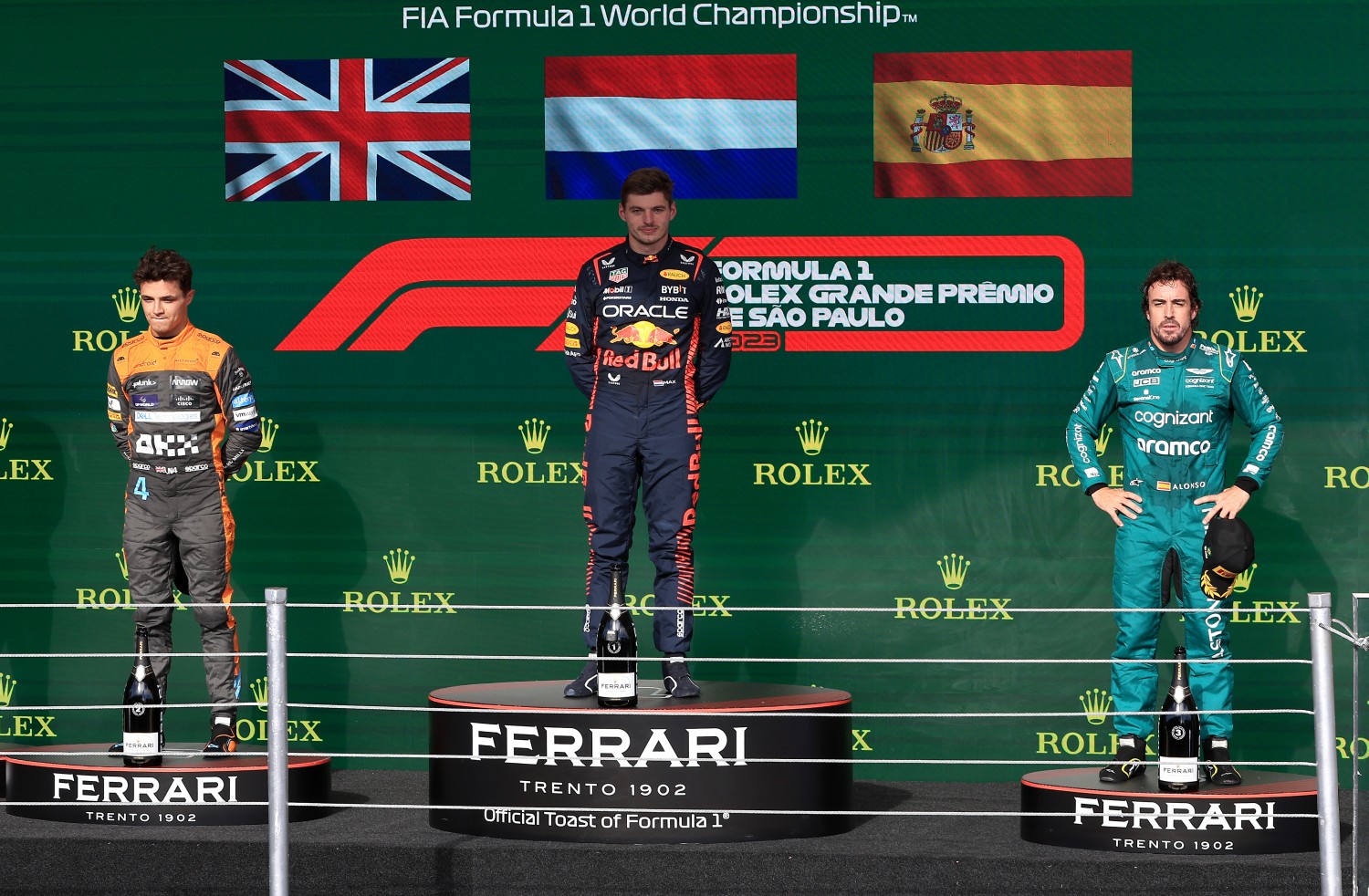 Race winner Max Verstappen of the Netherlands and Oracle Red Bull Racing (C), Second placed Lando Norris of Great Britain and McLaren (L) and Third placed Fernando Alonso of Spain and Aston Martin F1 Team (R) stand on the podium during the F1 Grand Prix of Brazil at Autodromo Jose Carlos Pace on November 05, 2023 in Sao Paulo, Brazil. (Photo by Buda Mendes/Getty Images)