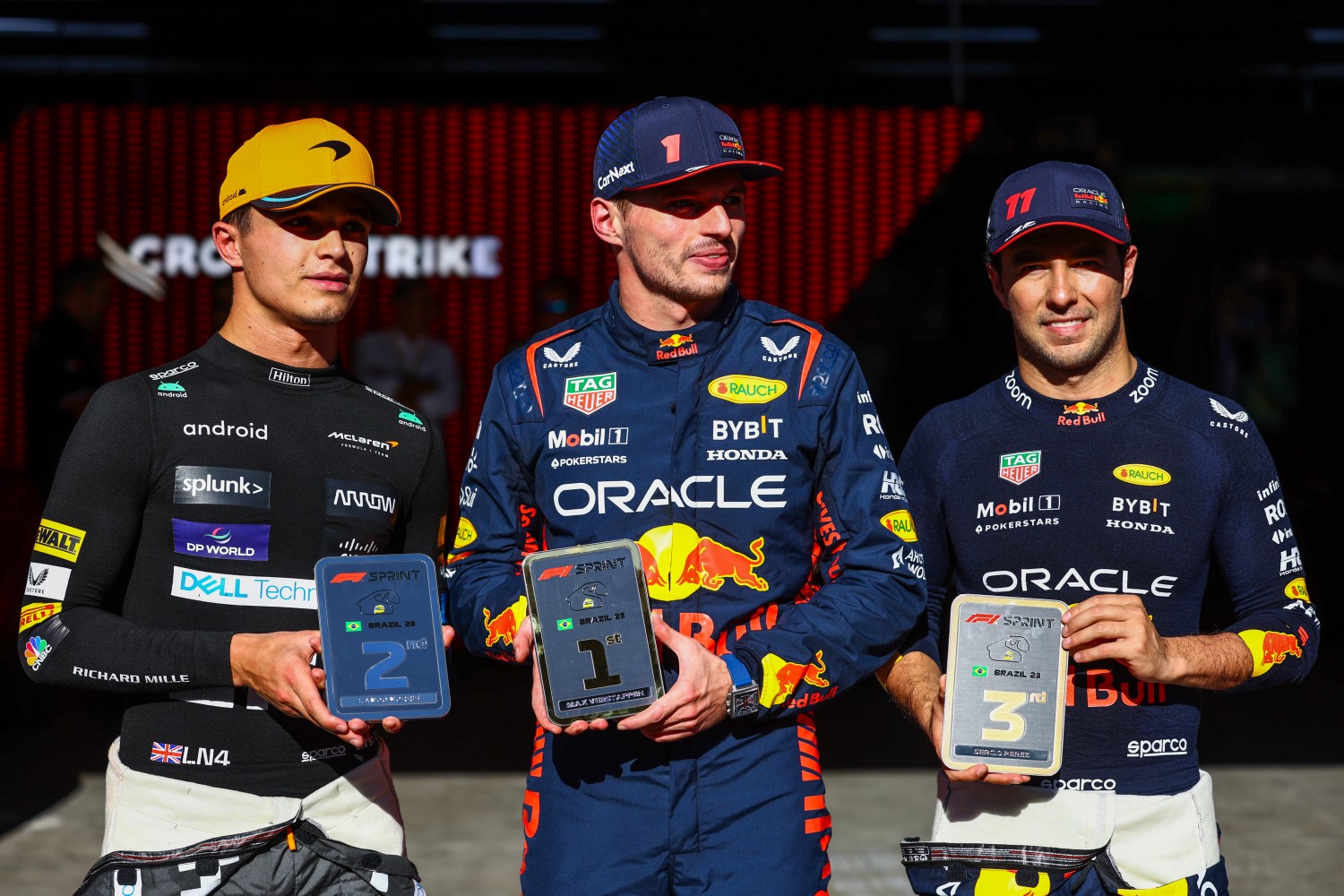 Sprint winner Max Verstappen of the Netherlands and Oracle Red Bull Racing (C), Second placed Lando Norris of Great Britain and McLaren and Third placed Sergio Perez of Mexico and Oracle Red Bull Racing celebrate in parc ferme during the Sprint ahead of the F1 Grand Prix of Brazil at Autodromo Jose Carlos Pace on November 04, 2023 in Sao Paulo, Brazil. (Photo by Mark Thompson/Getty Images) // Getty Images / Red Bull Content Pool